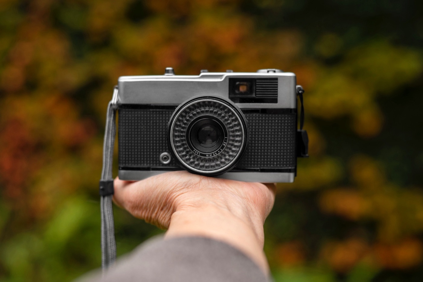 A person holding a camera on his hand